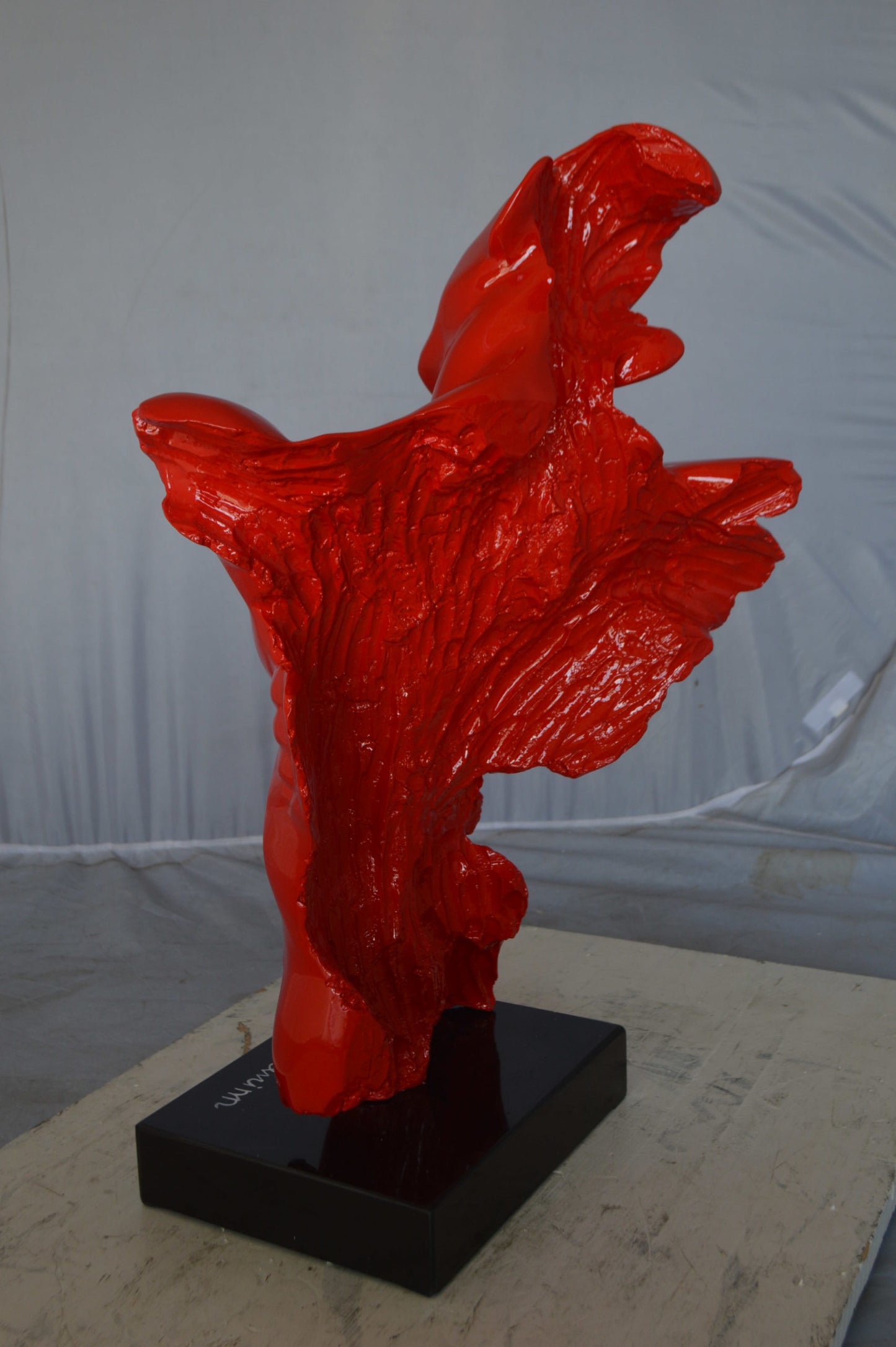 Modern resin statue of a man hugged by a woman -  Size: 17"L x 8"W x 24"H.