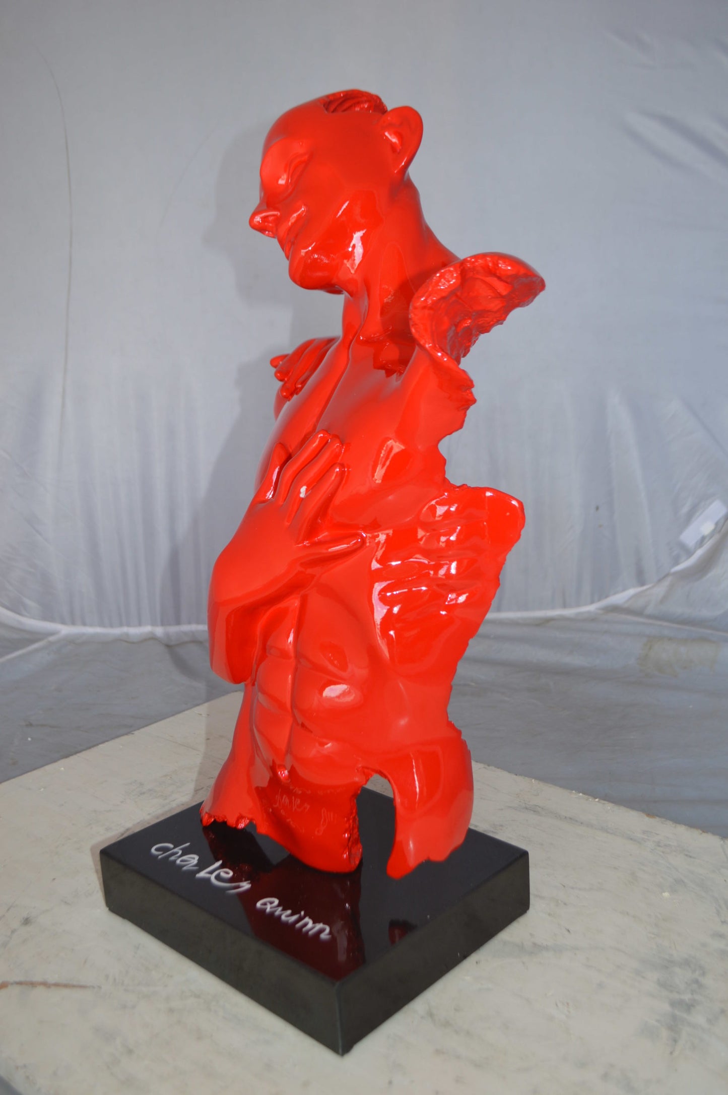Modern resin statue of a man hugged by a woman -  Size: 17"L x 8"W x 24"H.