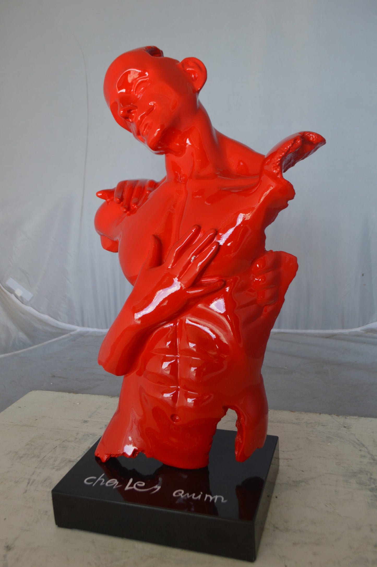 Modern resin statue of a man hugged by a woman -  Size: 17"L x 8"W x 24"H.