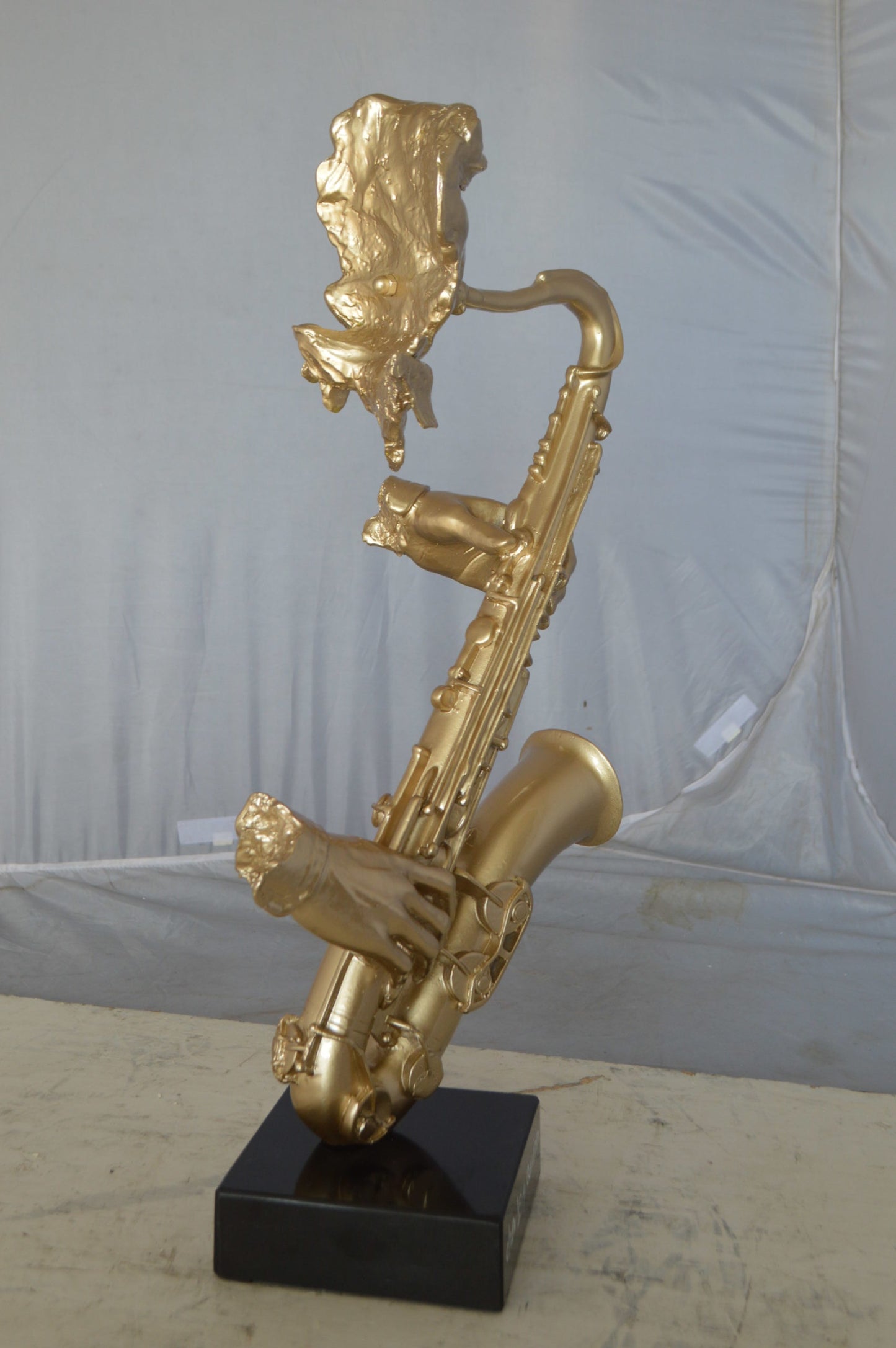 Modern art of a saxophone player resin statue -  Size: 13"L x 5"W x 25"H.