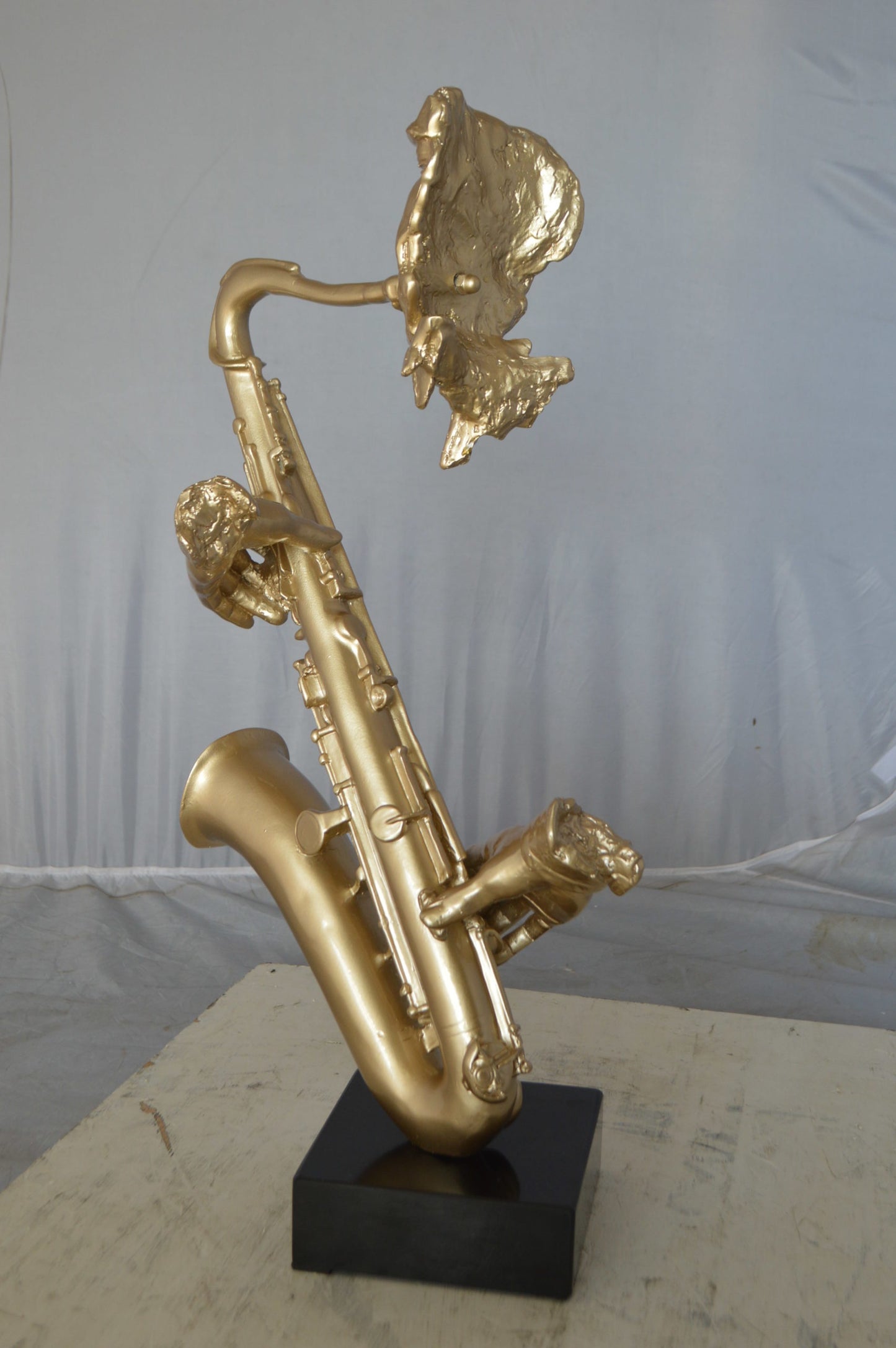 Modern art of a saxophone player resin statue -  Size: 13"L x 5"W x 25"H.