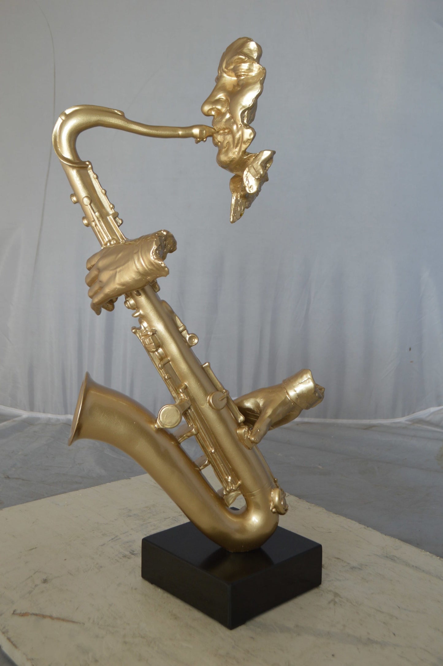 Modern art of a saxophone player resin statue -  Size: 13"L x 5"W x 25"H.