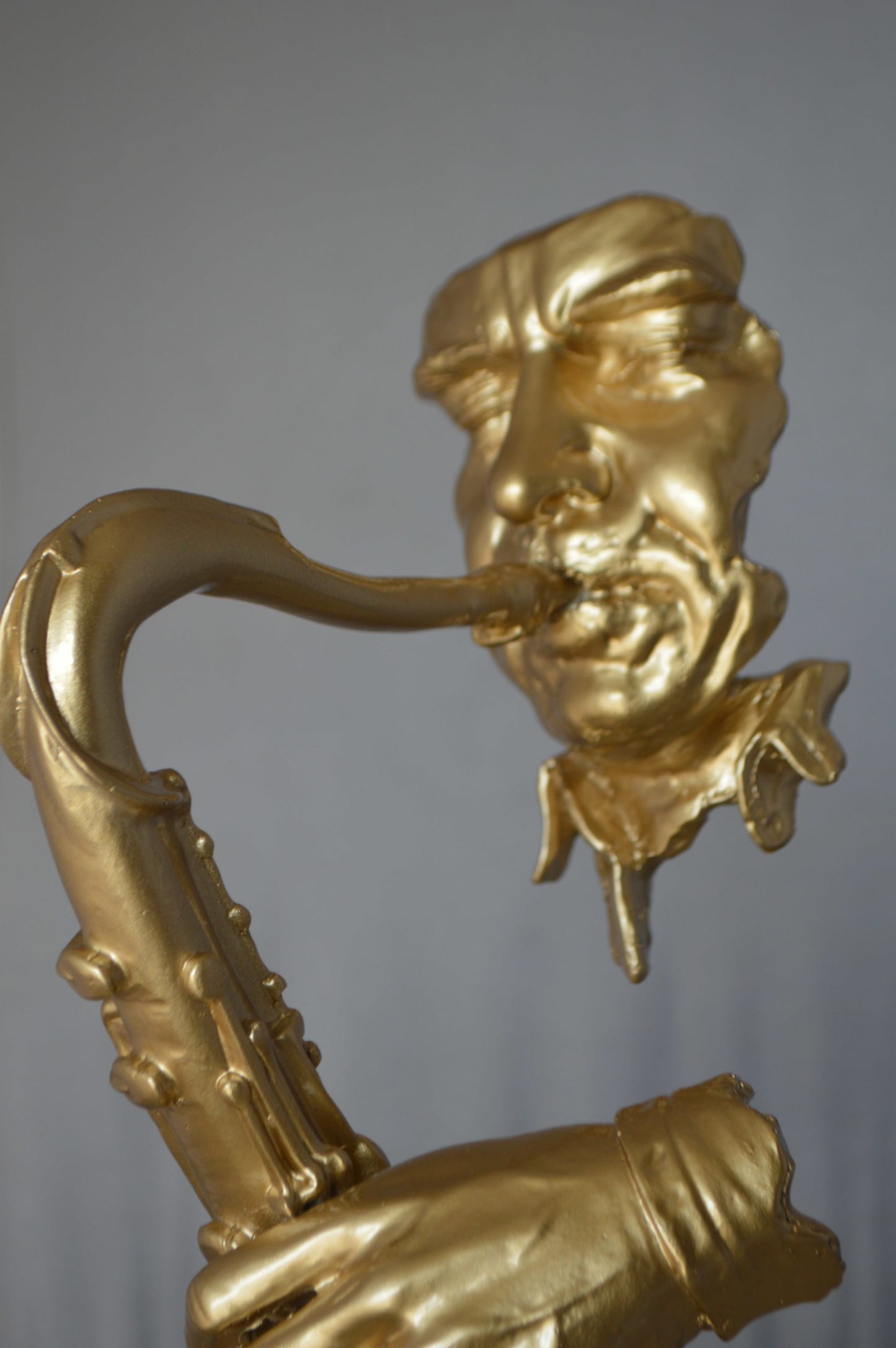 Modern art of a saxophone player resin statue -  Size: 13"L x 5"W x 25"H.