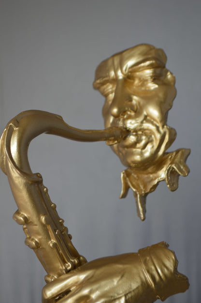 Modern art of a saxophone player resin statue -  Size: 13"L x 5"W x 25"H.