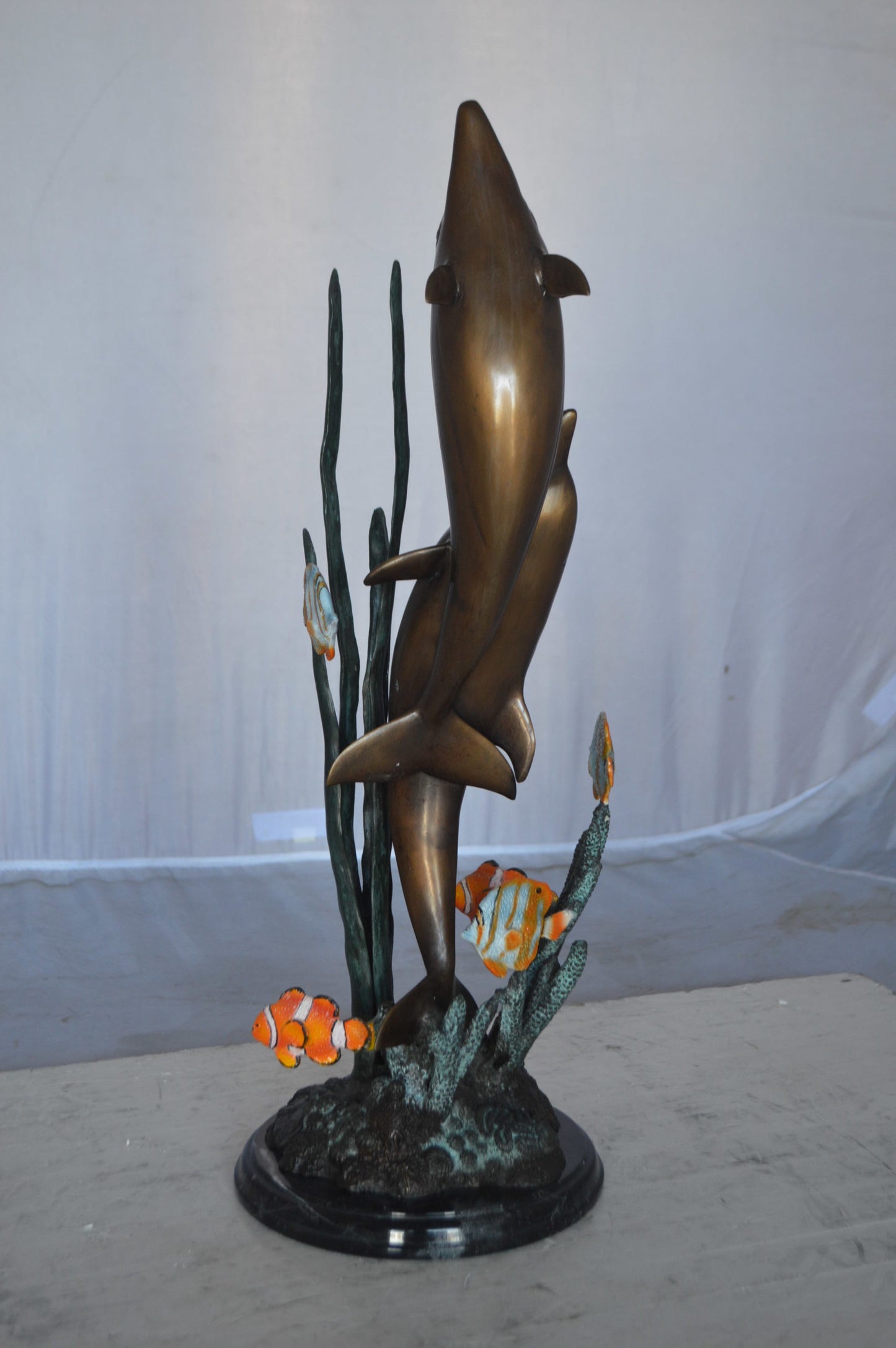 Two dolphins with fish, table top bronze statue. -  Size: 8"L x 8"W x 22"H.