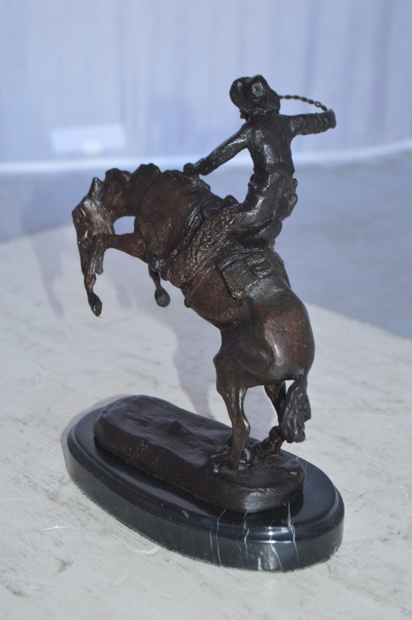 Wooly Chaps Bronze Statue by Remington 13H -  Size: 8"L x 3"W x 9"H.