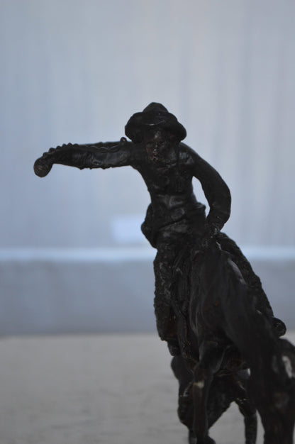 Wooly Chaps Bronze Statue by Remington 13H -  Size: 8"L x 3"W x 9"H.