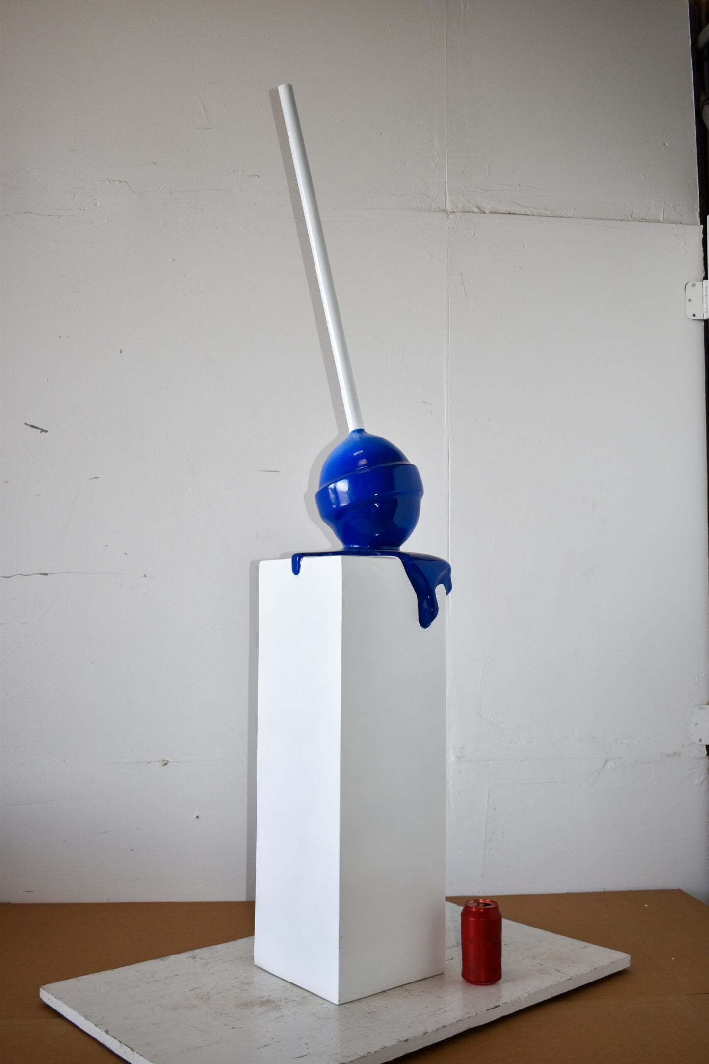 Blue Lollipop Mounted on A White Pedestal Resin Statue Size: 10" x 10" x 59"H