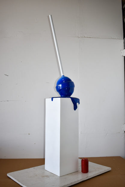 Blue Lollipop Mounted on A White Pedestal Resin Statue Size: 10" x 10" x 59"H