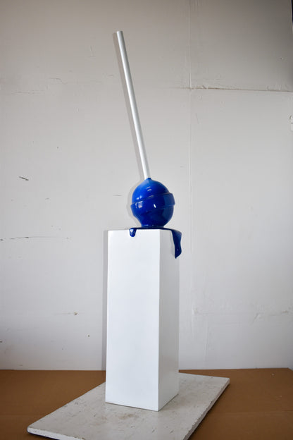 Blue Lollipop Mounted on A White Pedestal Resin Statue Size: 10" x 10" x 59"H