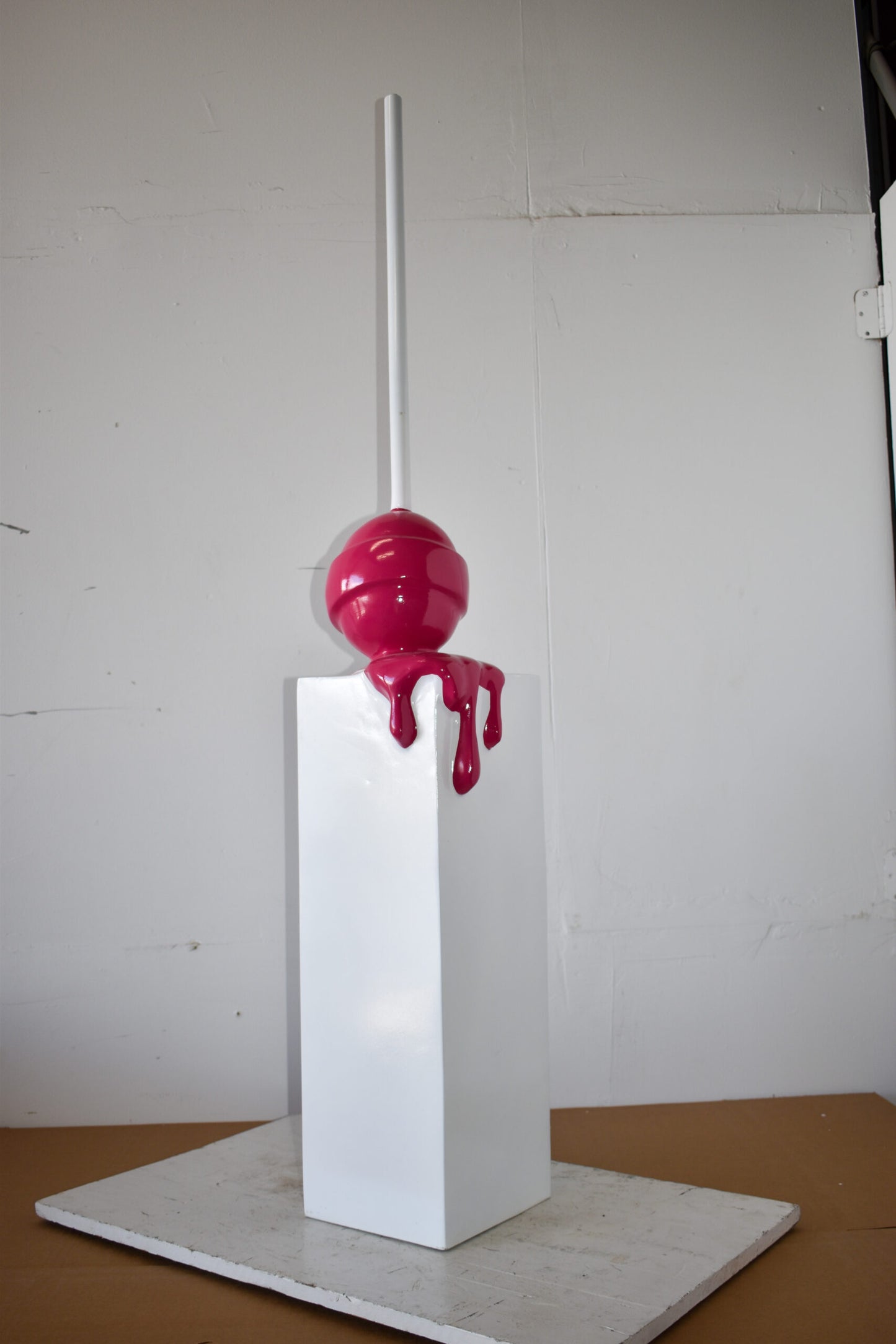 Red Lollipop Mounted on A White Pedestal Resin Statue Size: 10" x 10" x 59"H