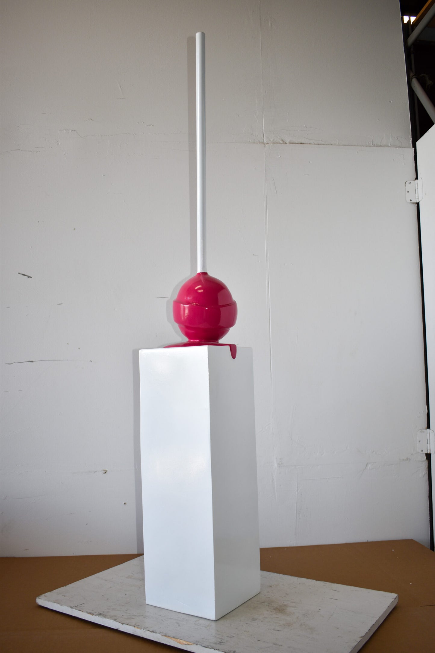 Red Lollipop Mounted on A White Pedestal Resin Statue Size: 10" x 10" x 59"H