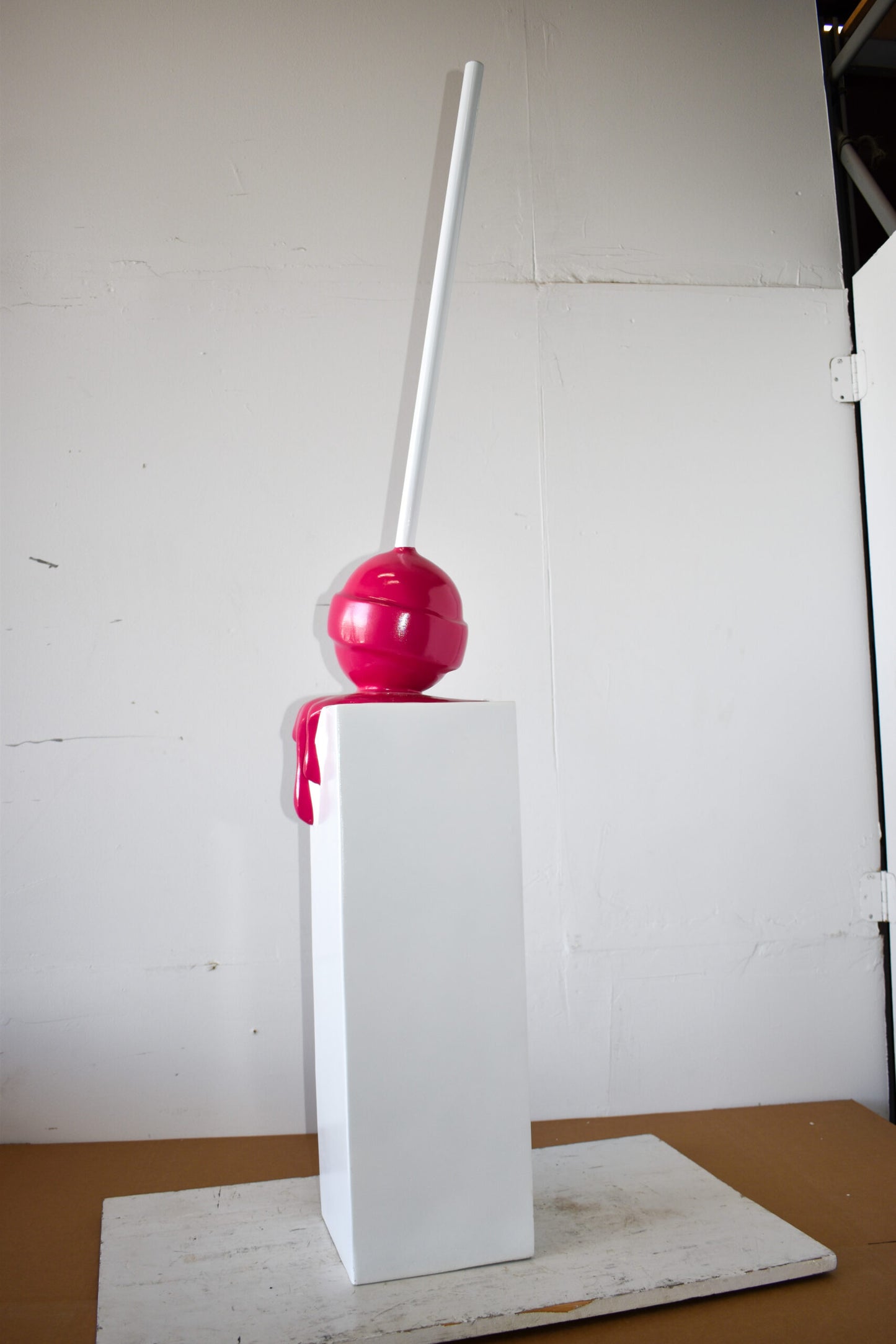 Red Lollipop Mounted on A White Pedestal Resin Statue Size: 10" x 10" x 59"H