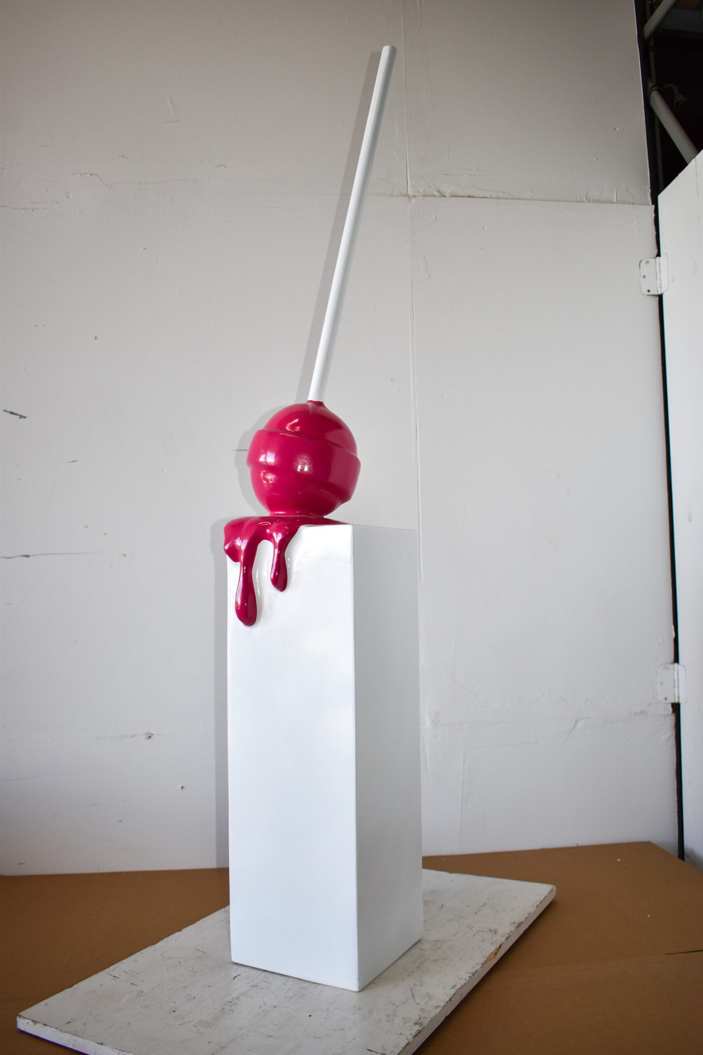 Red Lollipop Mounted on A White Pedestal Resin Statue Size: 10" x 10" x 59"H