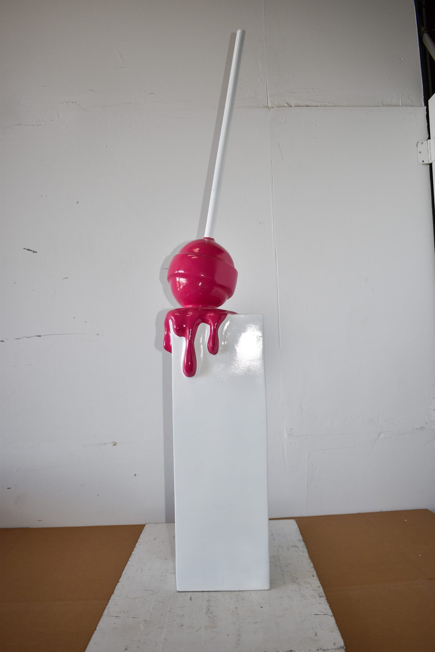 Red Lollipop Mounted on A White Pedestal Resin Statue Size: 10" x 10" x 59"H