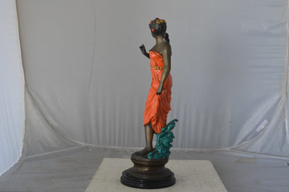 Young lady in orange bronze statue - Size: 7"L x 26"W x 25"H.