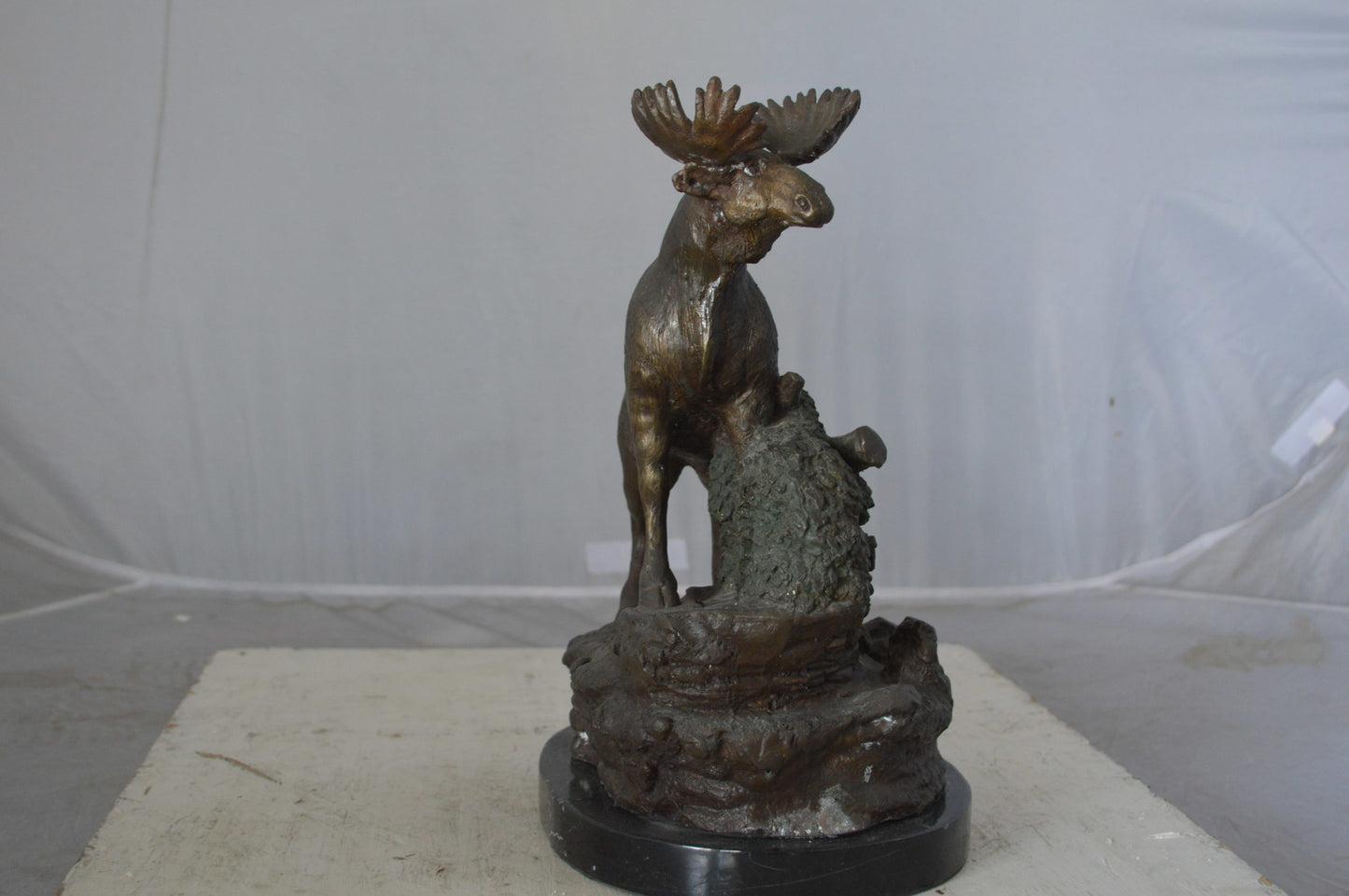 Moose on a rock bronze statue - Size: 9"L x 7"W x 14"H.
