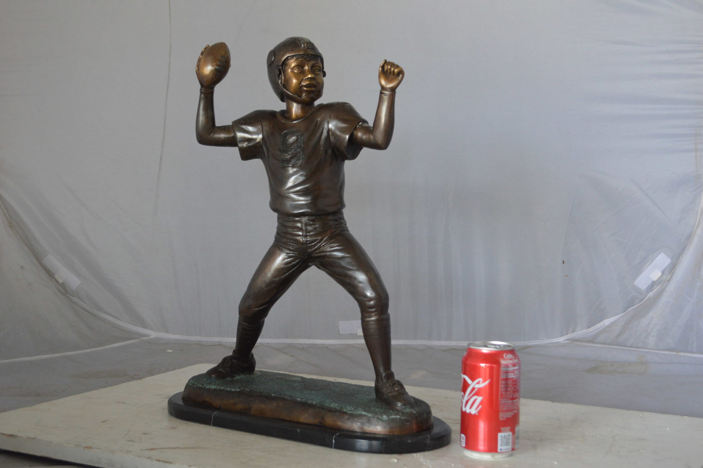Young Quarterback bronze statue - Size: 14"L x 6"W x 20"H.