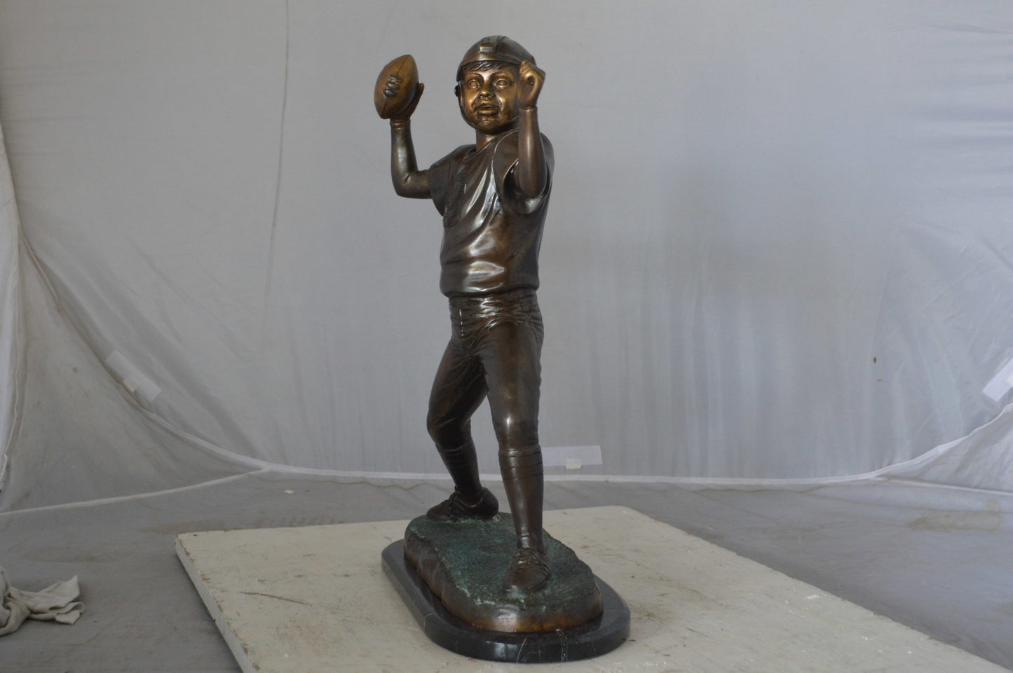 Young Quarterback bronze statue - Size: 14"L x 6"W x 20"H.