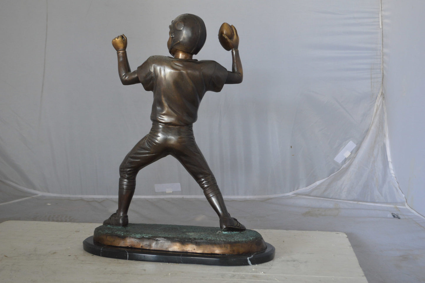 Young Quarterback bronze statue - Size: 14"L x 6"W x 20"H.