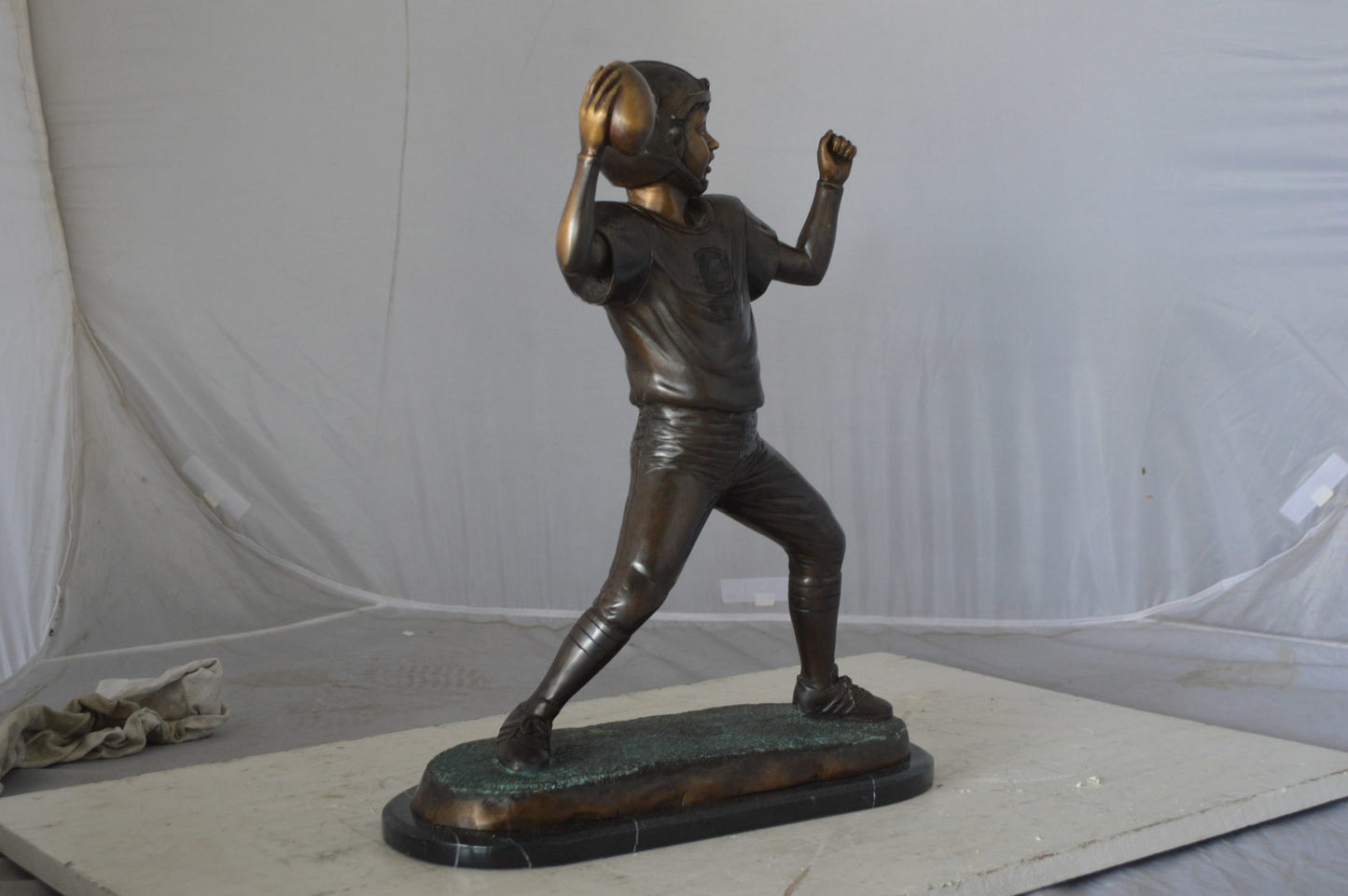Young Quarterback bronze statue - Size: 14"L x 6"W x 20"H.