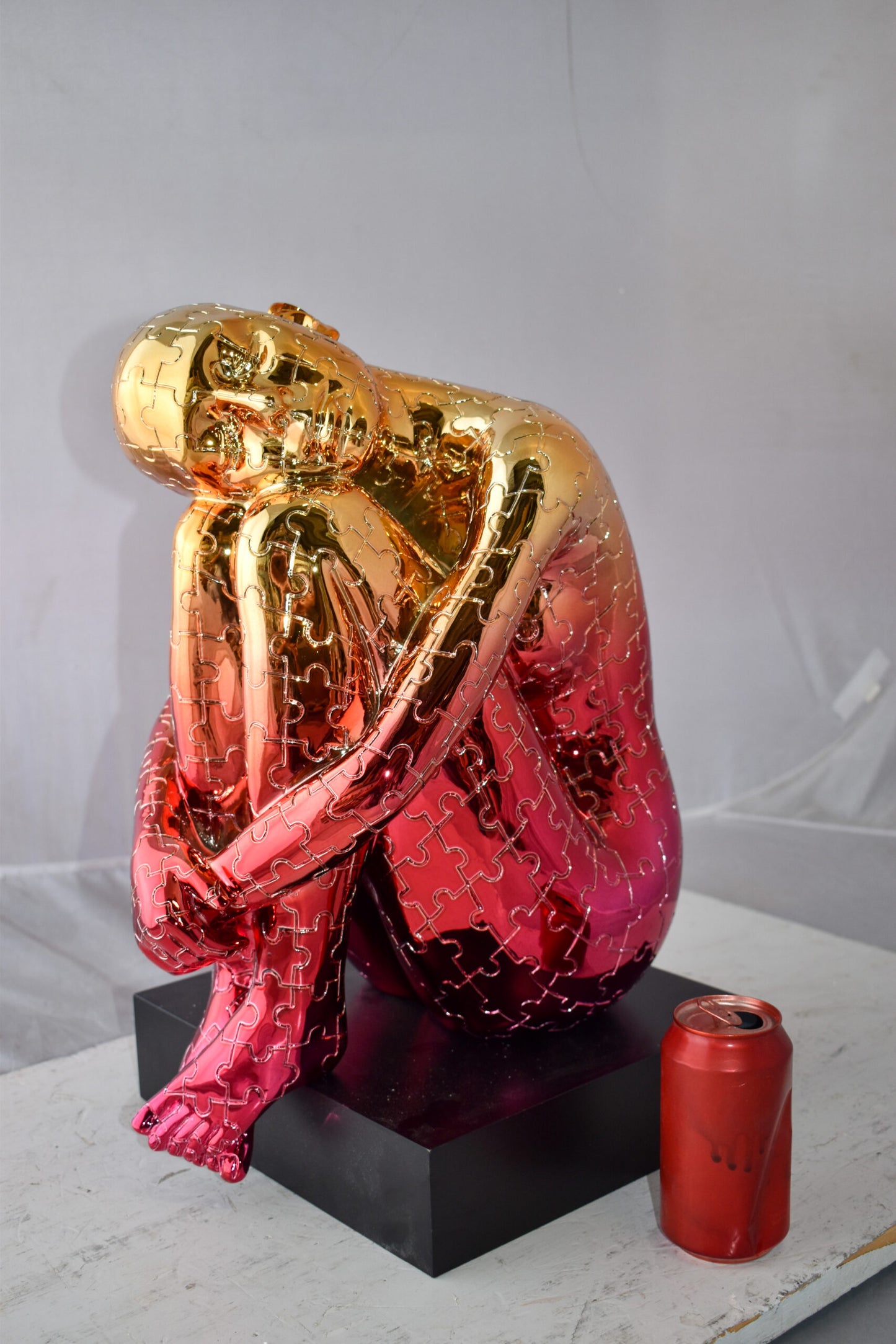 Puzzle Patterned Cradled Woman Resin Statue on Black Base Size: 13" x 12" x 19"H