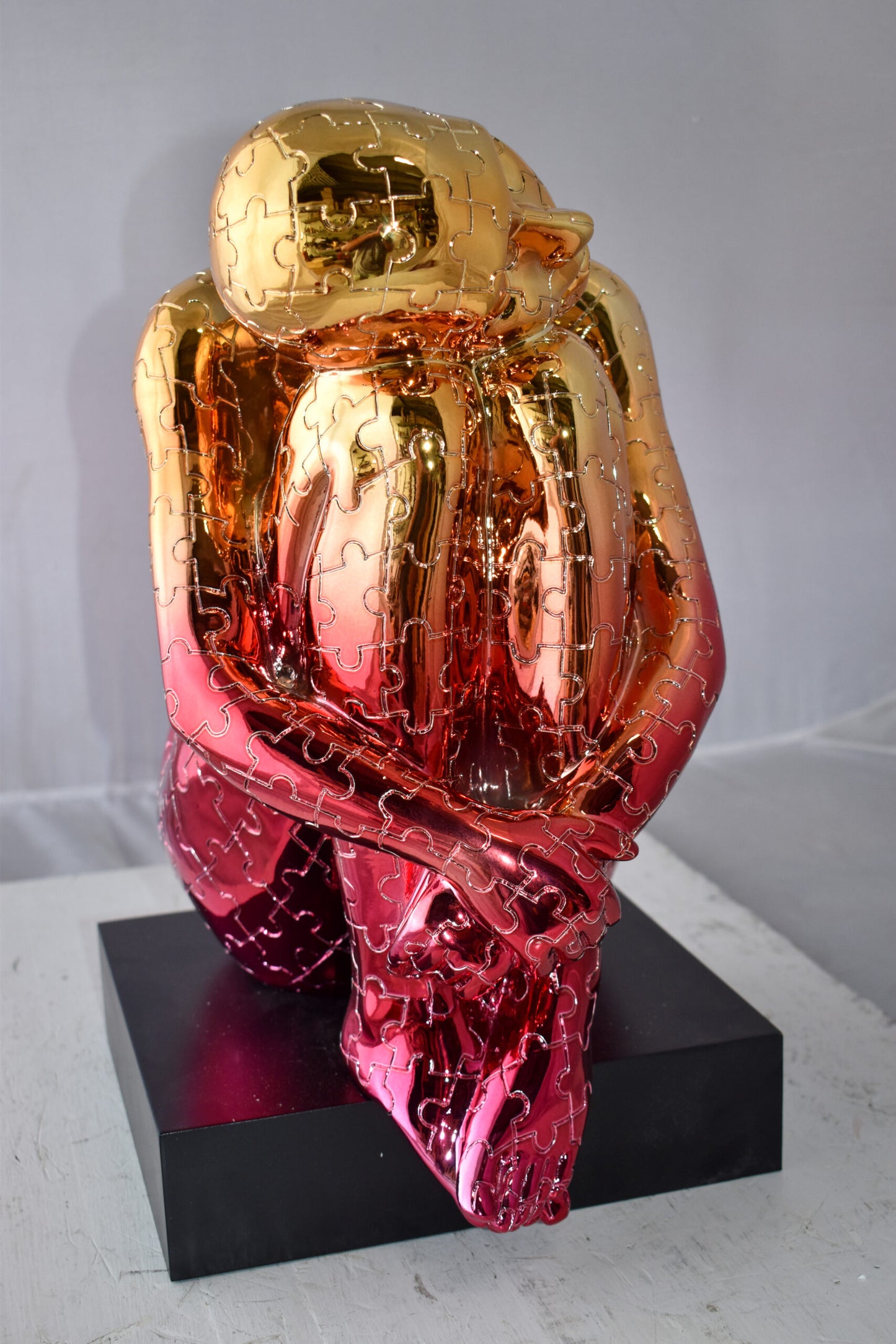 Puzzle Patterned Cradled Woman Resin Statue on Black Base Size: 13" x 12" x 19"H