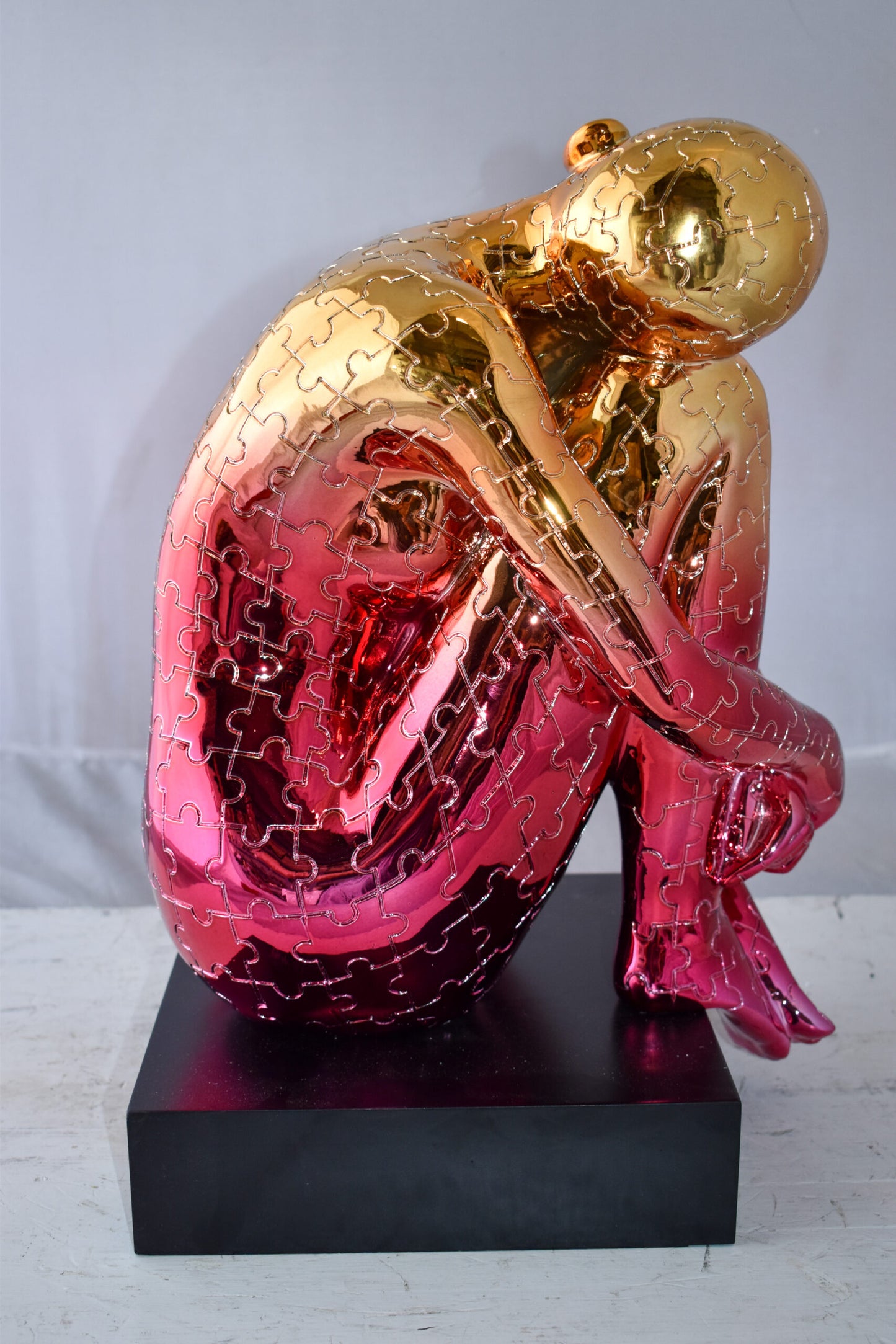 Puzzle Patterned Cradled Woman Resin Statue on Black Base Size: 13" x 12" x 19"H
