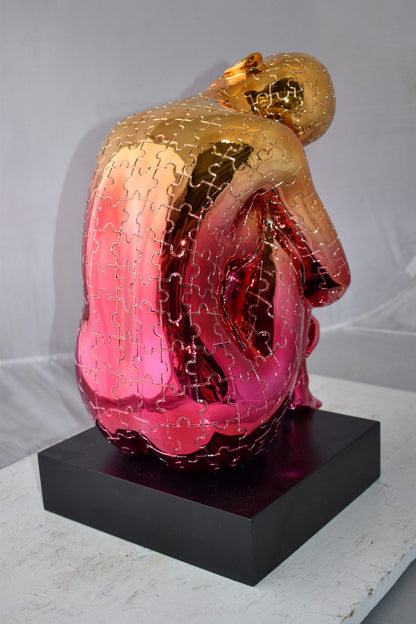 Puzzle Patterned Cradled Woman Resin Statue on Black Base Size: 13" x 12" x 19"H