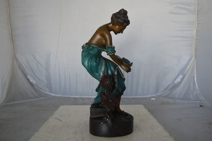 Lady holding a bird bronze statue - Size: 10"L x 9"W x 20"H.