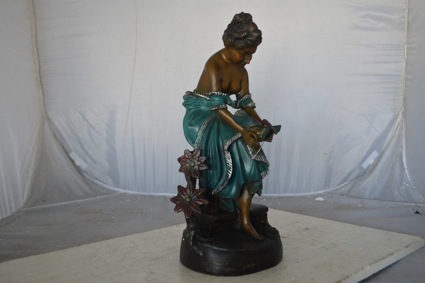 Lady holding a bird bronze statue - Size: 10"L x 9"W x 20"H.