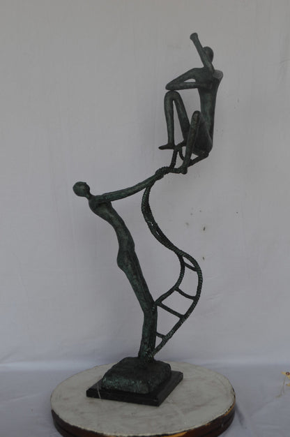Modern art, two men climbing a latter bronze statue - Size: 14"L x 15"W x 47"H.