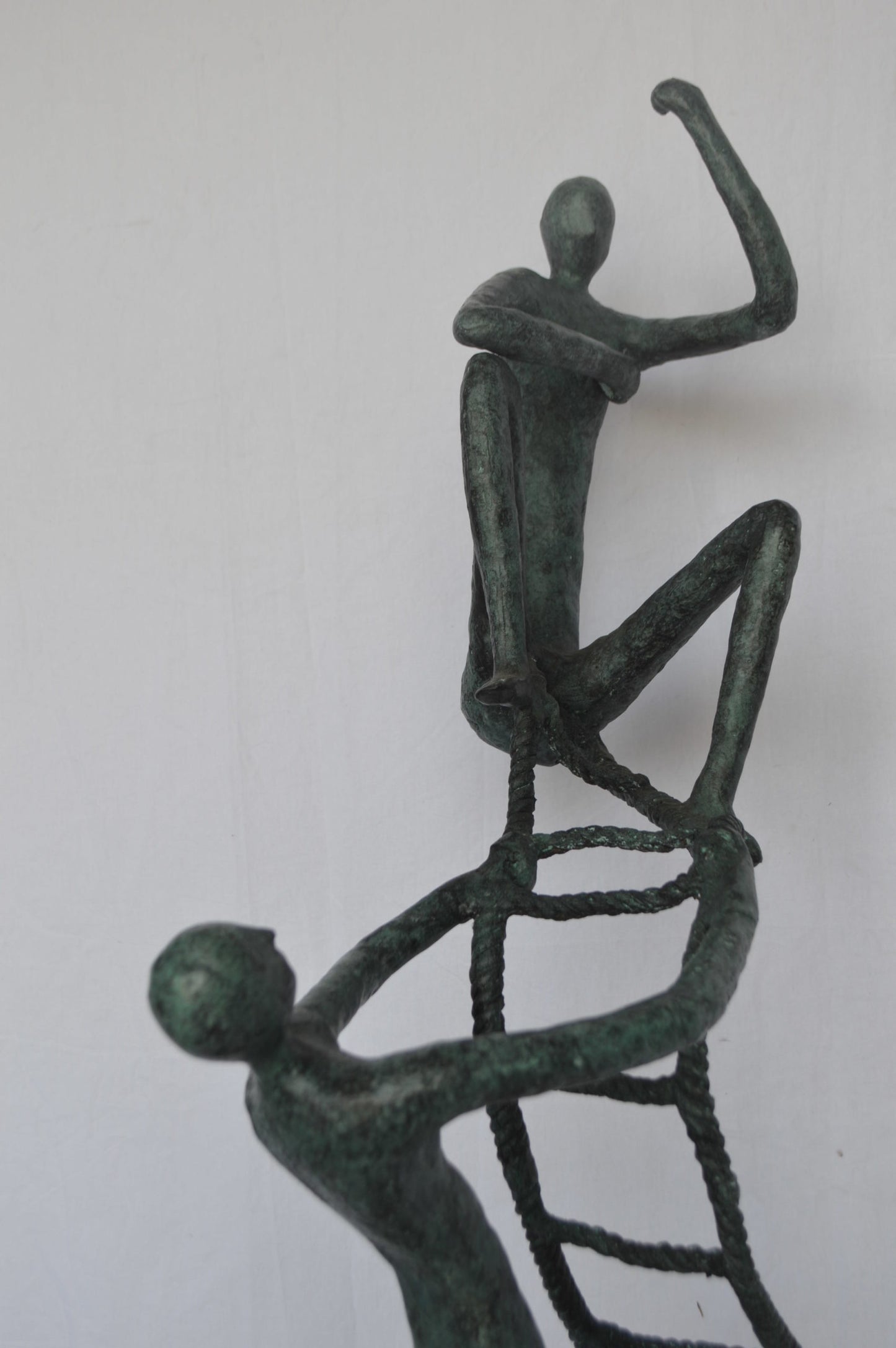 Modern art, two men climbing a latter bronze statue - Size: 14"L x 15"W x 47"H.