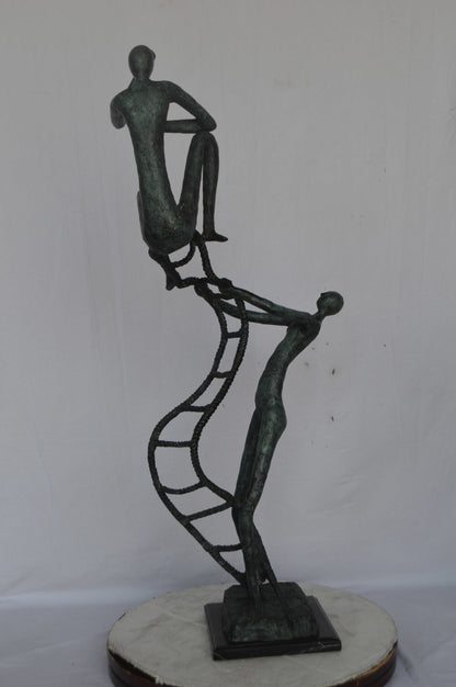 Modern art, two men climbing a latter bronze statue - Size: 14"L x 15"W x 47"H.