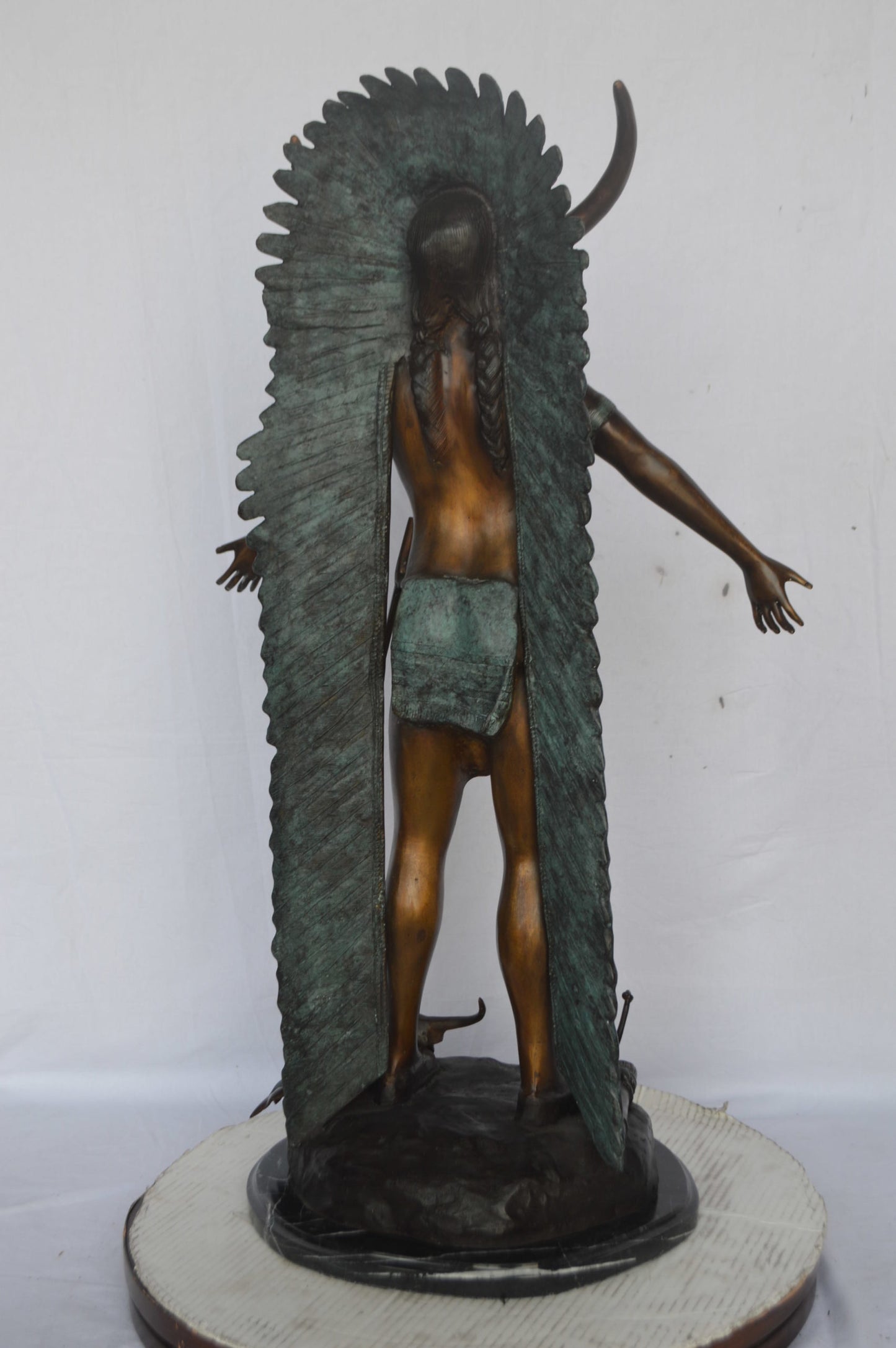 Indian with Plume bronze statue - Size: 22"L x 14"W x 38"H.