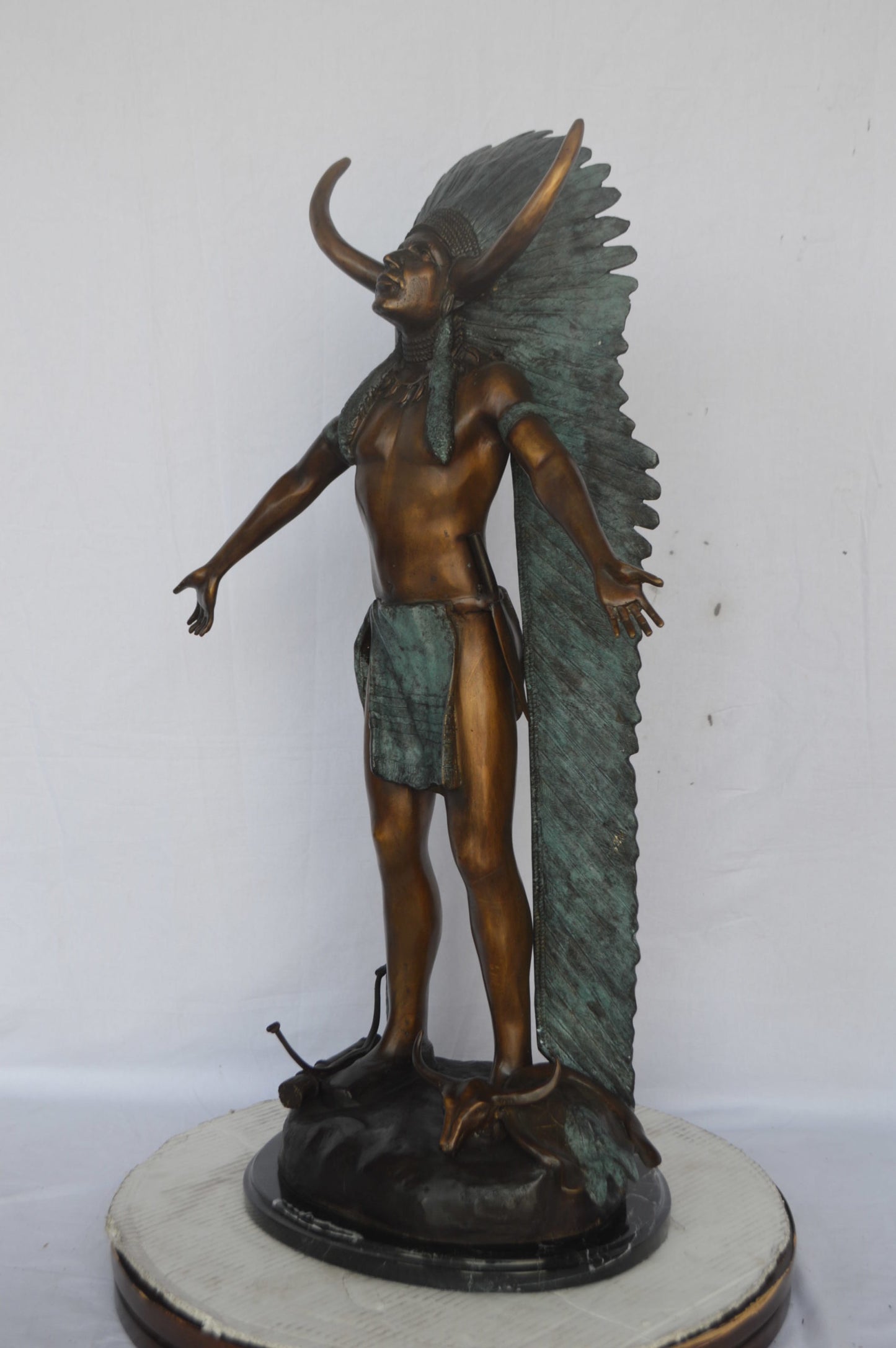 Indian with Plume bronze statue - Size: 22"L x 14"W x 38"H.