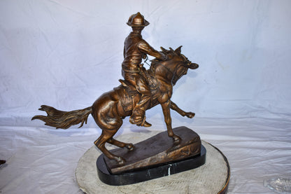 Cowboy Remington Replica Bronze Statue on Triple Marble Size: 25" x 8" x 24"H