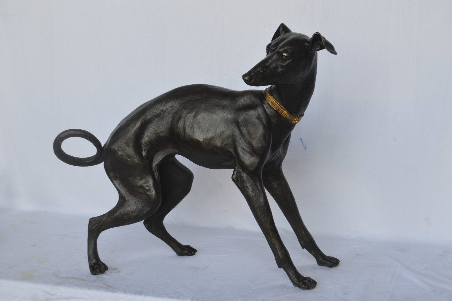 Whipped Dog bronze statue - Size: 33"L x 13"W x 30"H.