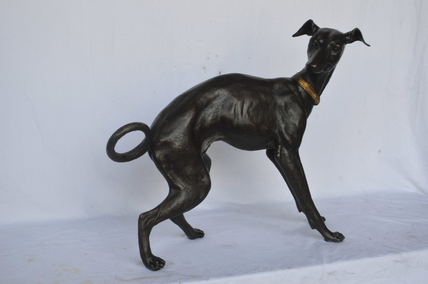 Whipped Dog bronze statue - Size: 33"L x 13"W x 30"H.