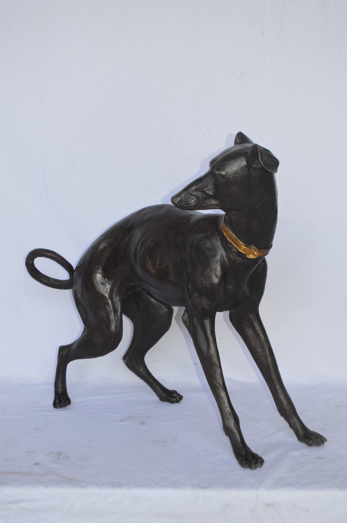 Whipped Dog bronze statue - Size: 33"L x 13"W x 30"H.