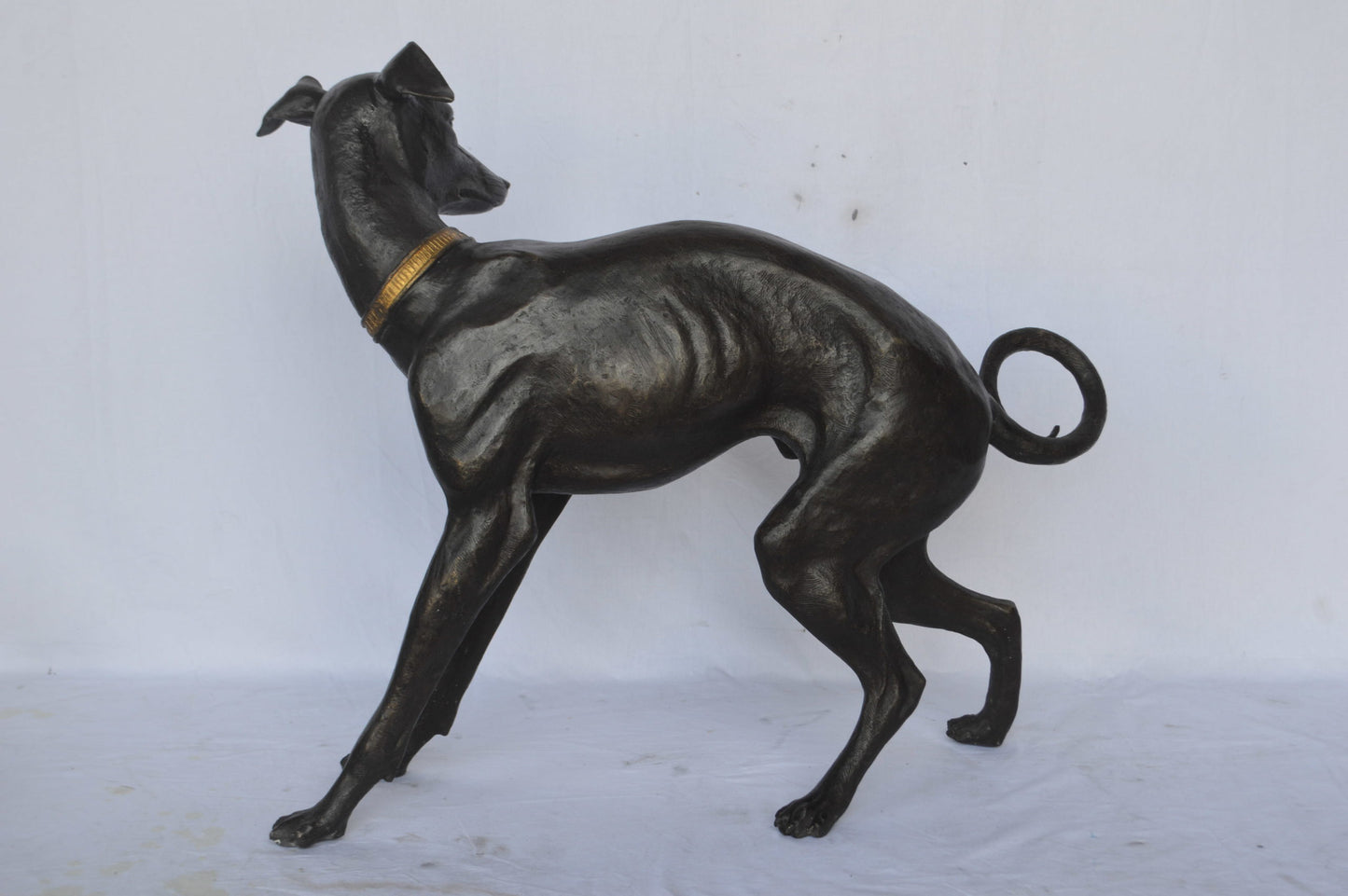 Whipped Dog bronze statue - Size: 33"L x 13"W x 30"H.