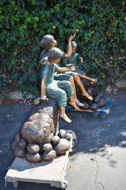 Three Kids Playing With Butterflies Bronze Statue -  Size: 70"L x 25"W x 45"H.