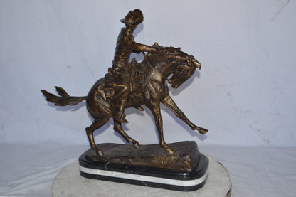 Cowboy Bronze replica by Fredric Remington - Size: 25"L x 9"W x 23"H.