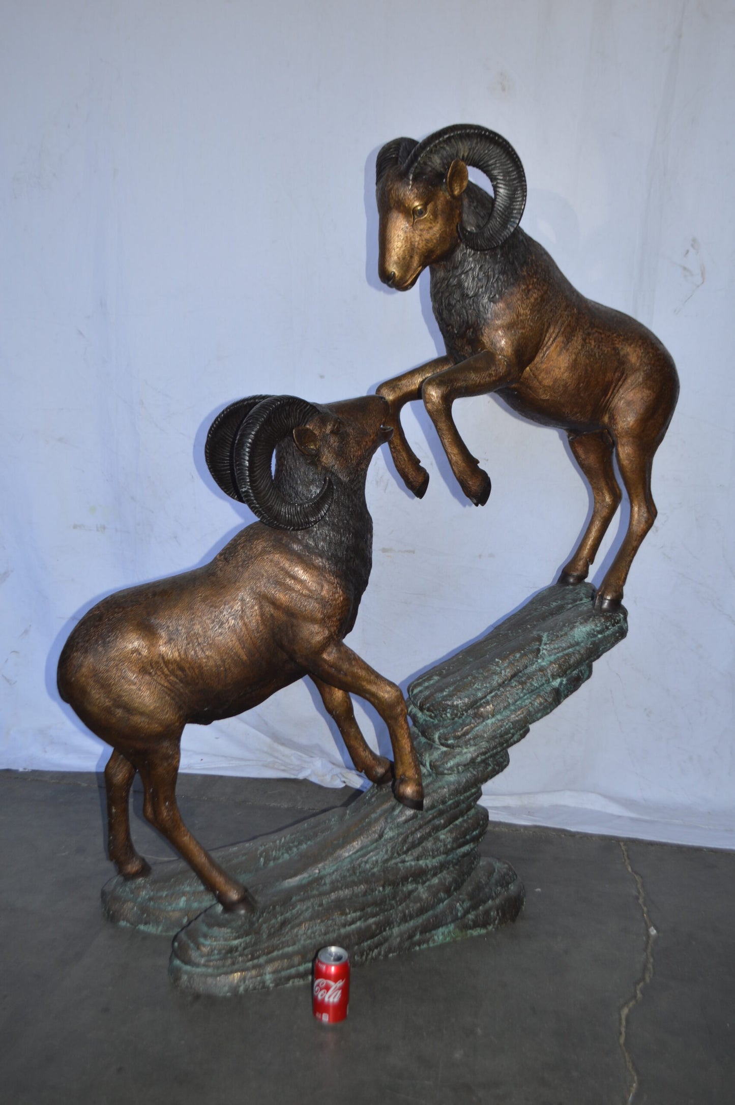 Two Life Size Rams on a rock Bronze Statue - Size: 49"L x 20"W x 64"H.