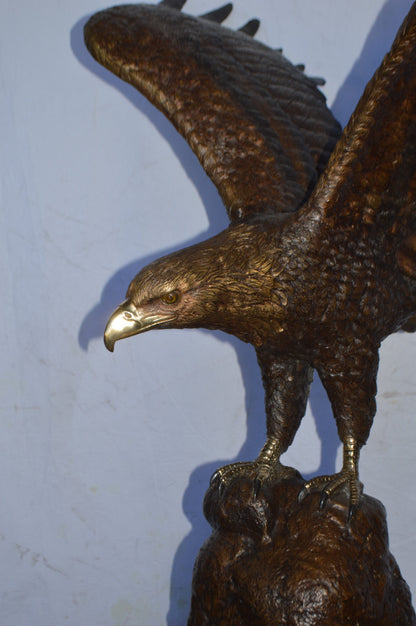 Eagle Landing on a Rock Bronze Statue - Size: 51"L x 36"W x 58"H.