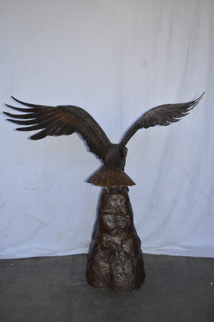 Eagle Landing on a Rock Bronze Statue - Size: 51"L x 36"W x 58"H.