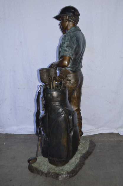 Golfer standing with his gear large bronze Statue - Size: 34"L x 21"W x 65"H.