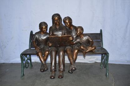 Mom and boys reading stories on bench bronze statue - Size: 53"L x 33"W x 39"H.