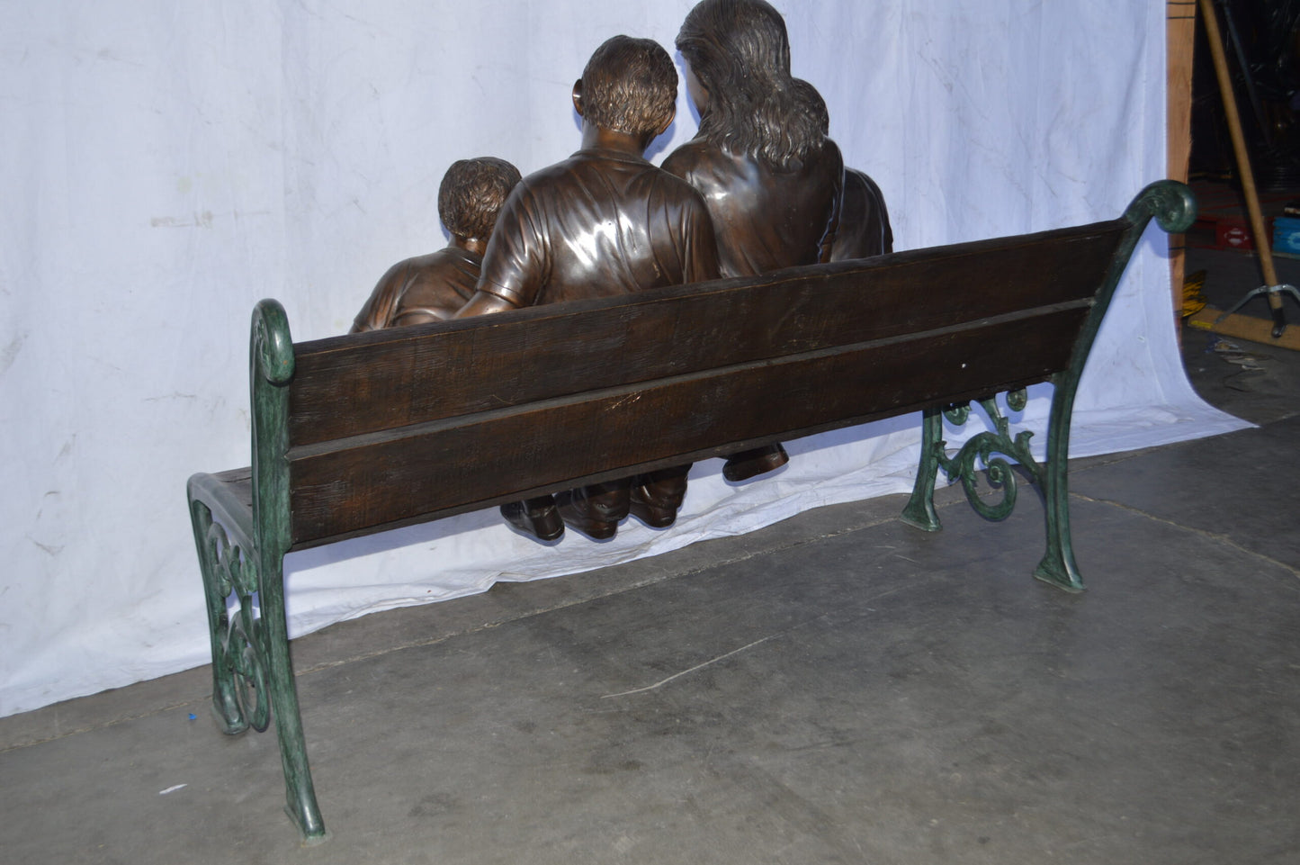 Mom and boys reading stories on bench bronze statue - Size: 53"L x 33"W x 39"H.