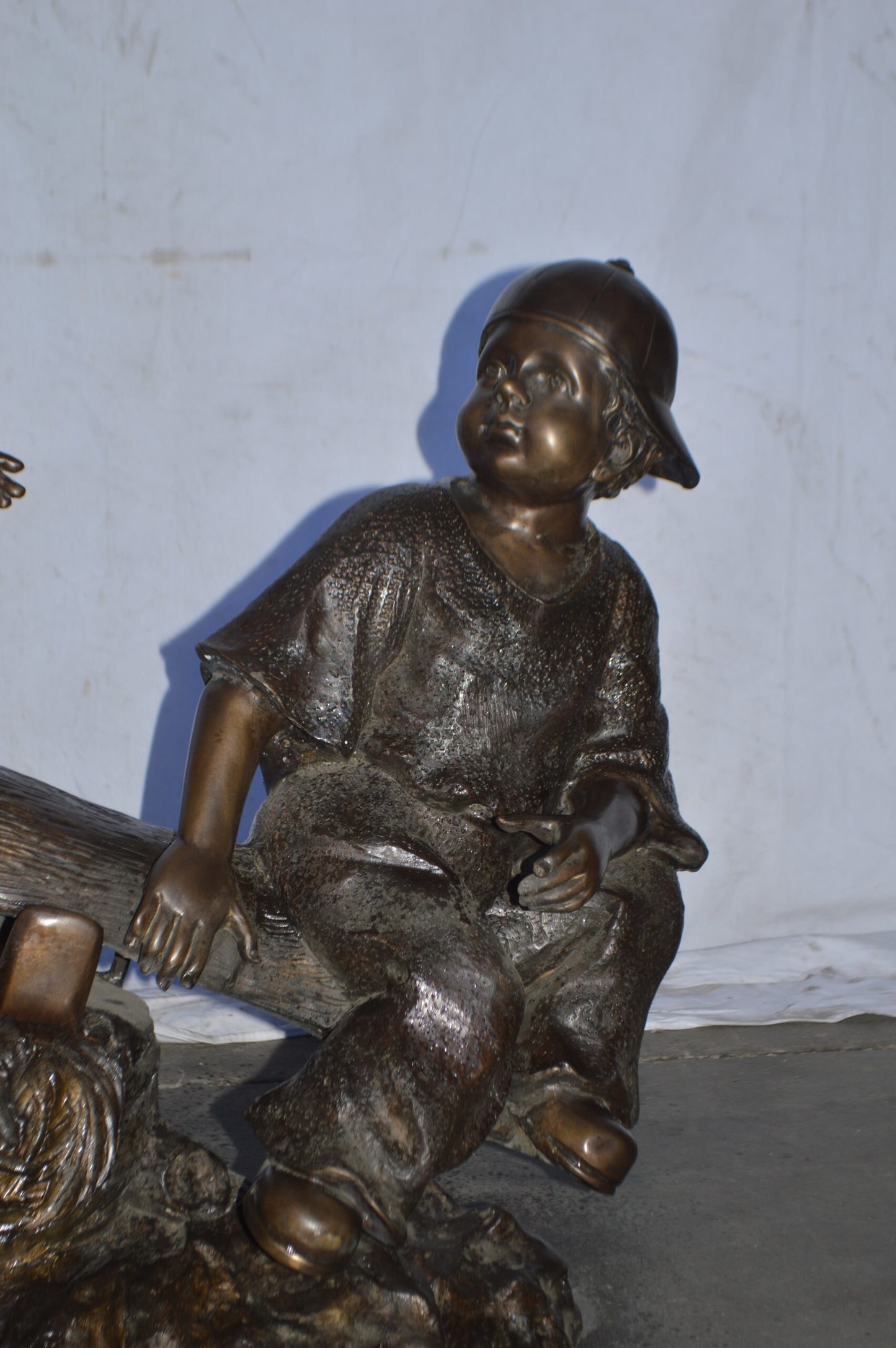 A Boy and a Girl Playing Seesaw Bronze Statue - Size: 17"L x 33"W x 36"H.